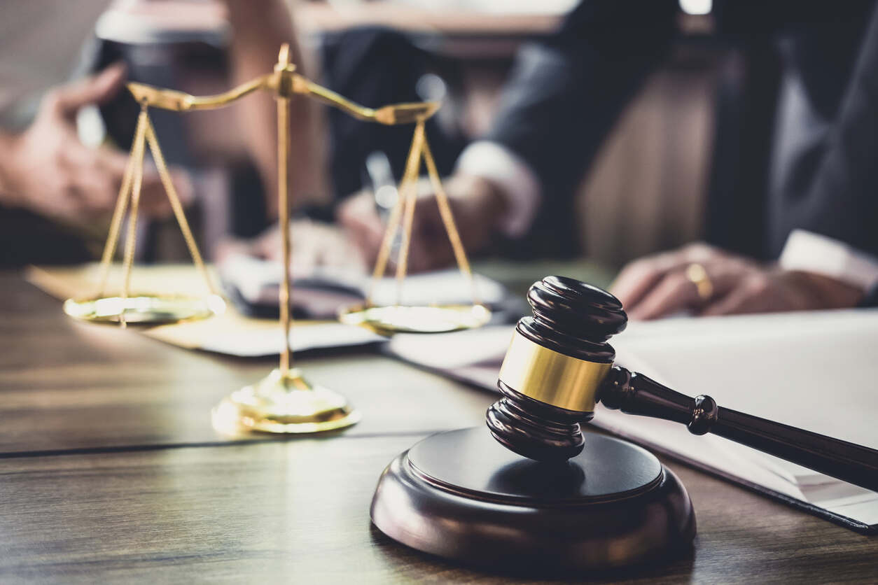 A lawyer at a desk with a gavel and scales of justice, symbolizing personal injury representation at logan.